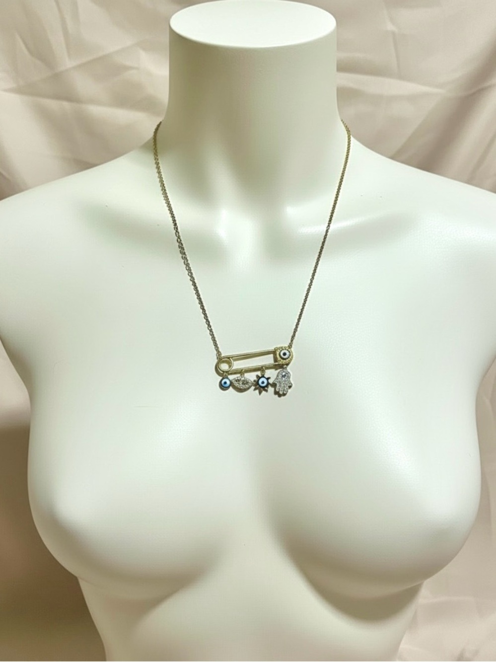 Gold-Tone Safety Pin Necklace with Blue, White and Gold Evil Eyes and a Hamsa